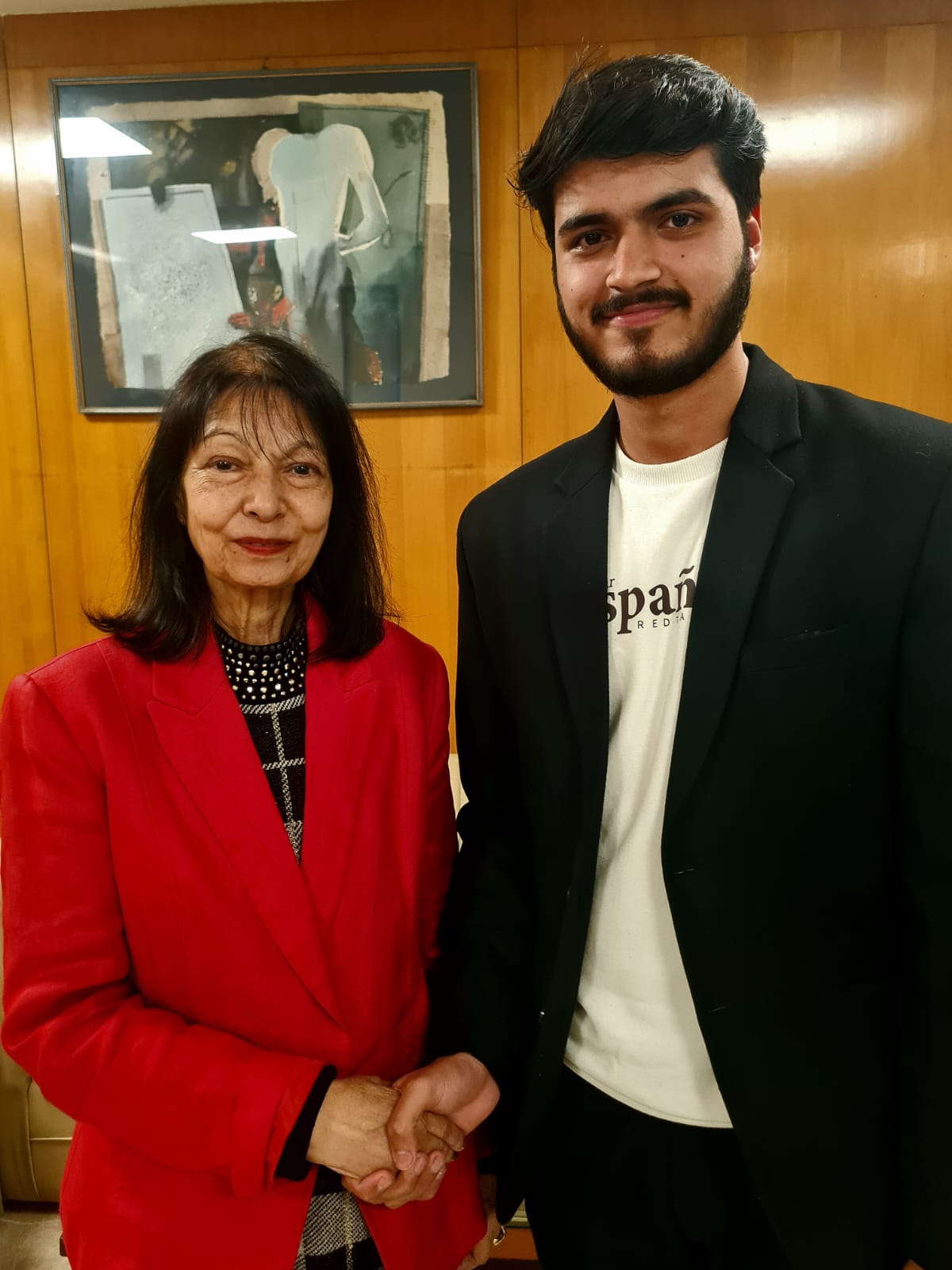 Akshat Mehrotra standing with the wife of H.E. Anil Sooklal (High Commissioner of South Africa).